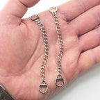 Close-up of the metal coat hangers showing the chain loop detail.
