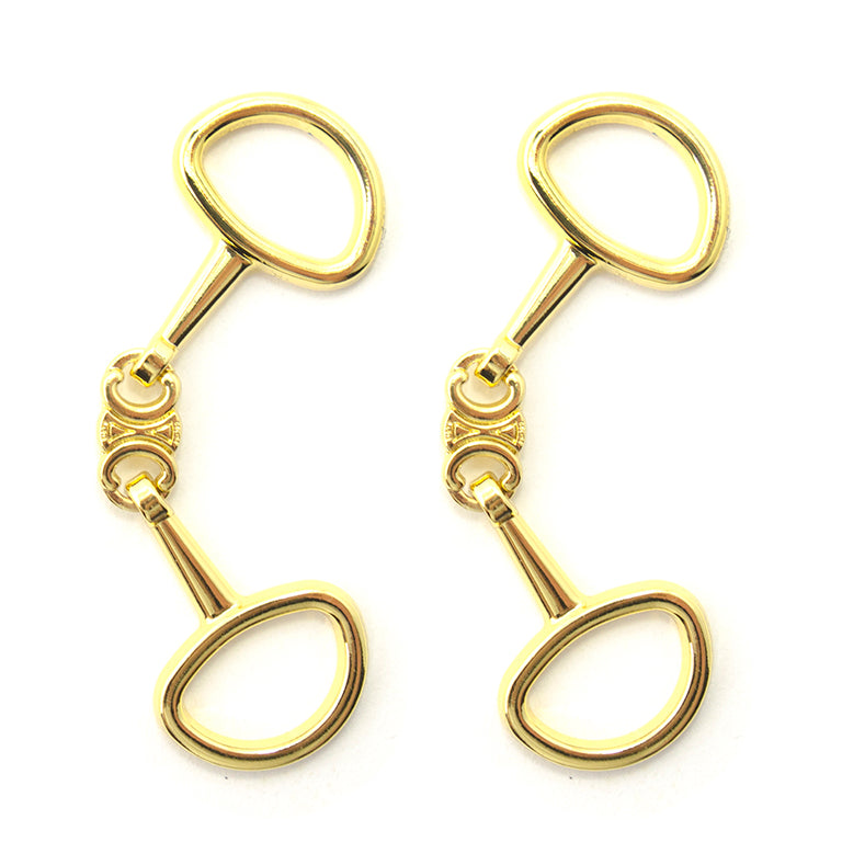 A pair of gold tone equestrian buckles with middle ornament details