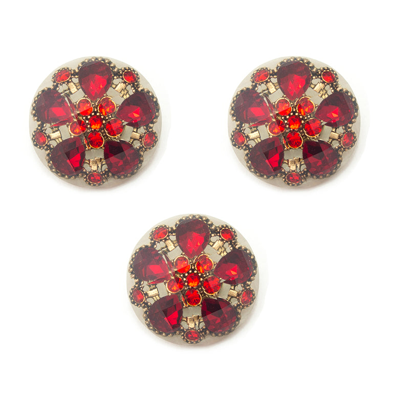 Set of 3 large red crystal buttons on a white background