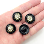 Close-up of 25 mm flower pattern diamante button with silver tone metal.