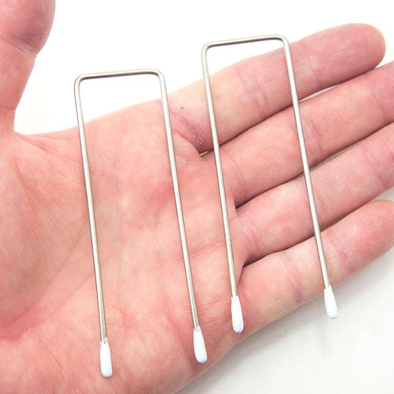 Close-up of metal square corsetry wires with enamel tips.