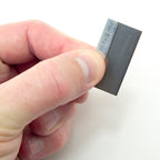 Close-up of a single edge razor blade showing the cutting edge.