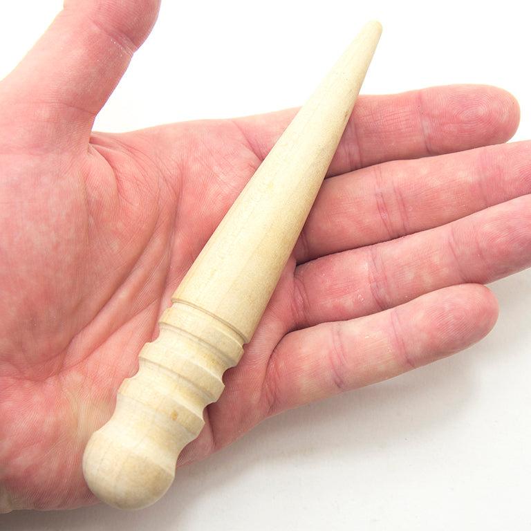 Close-up of the leather polish stick showing its grooves and dimensions.