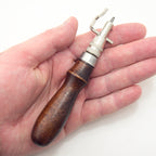 Close-up of edge beveller tips for leathercraft stitching tool.