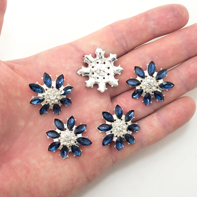Close-up of deep blue and clear crystal buttons, 28 mm diameter.