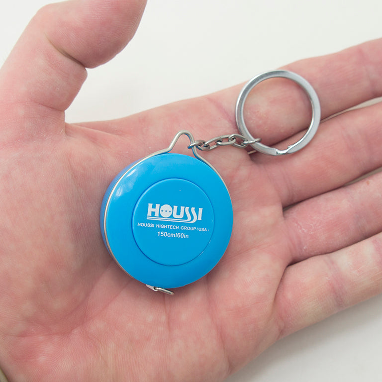 Close-up of the tape measure showing the quick release button.