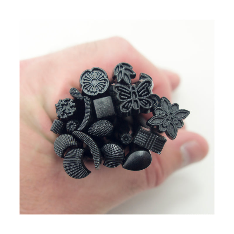 Set of 20 steel leather craft stamps in dark metal tone.