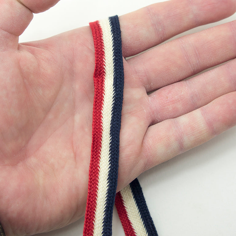 Cotton flat rope used for embellishing a garment.