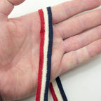 Cotton flat rope used for embellishing a garment.