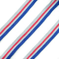 Red, blue, and grey flat rope trim on a white background