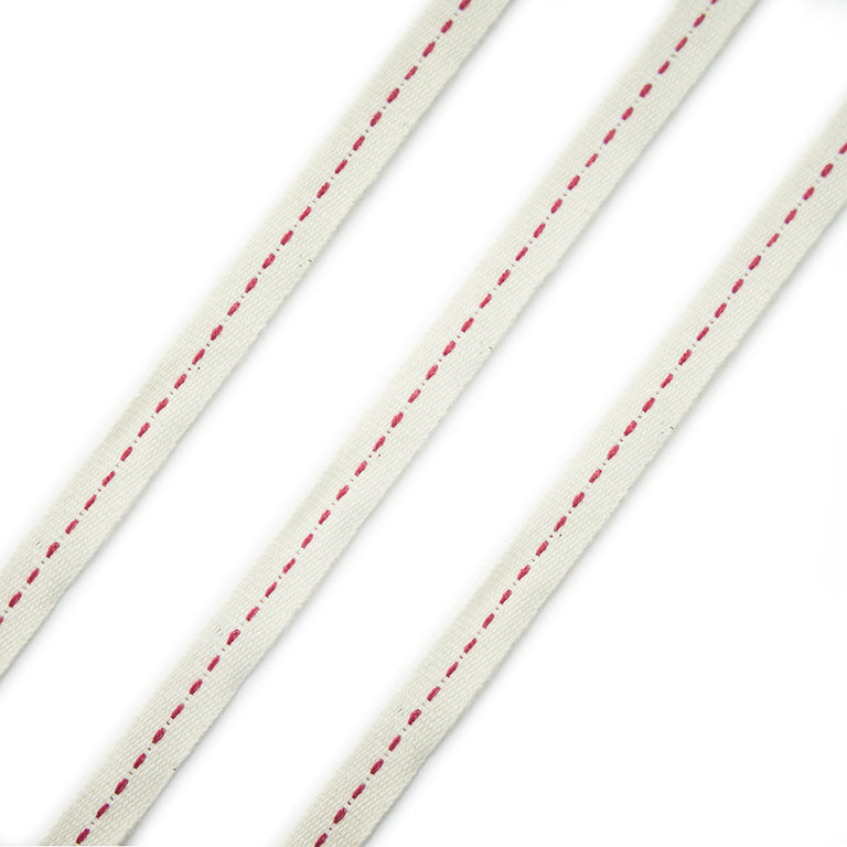 Cream and red cotton flat rope trim on a white background.