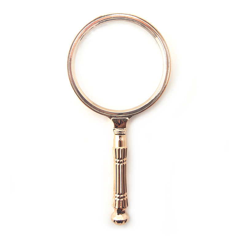 Magnifying glass with rose gold tone handle and 85 mm lens.