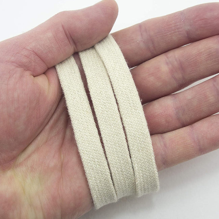 Close-up of 12 mm wide cream cotton rope trim showing texture.