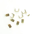 Ten gold tone brass zip stop ends for No.5 zips arranged in a pack.