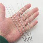 Close-up of steel V wires showing white enamel tips.