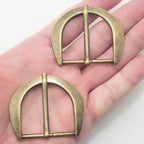 Close-up of antique brass gold tone buckle, perfect for crafting.