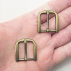 Close-up of antique brass tone buckle, 30 x 28 mm size.