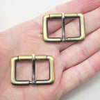 Close-up of antique brass tone buckle showing detail.