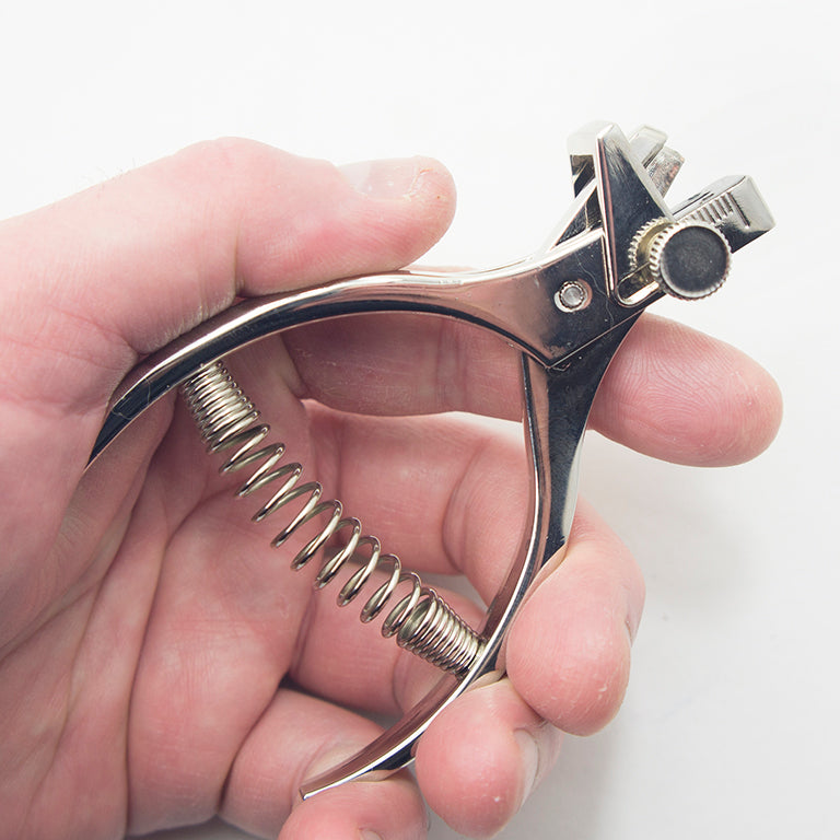 Close-up of notching pliers with adjustable guide feature