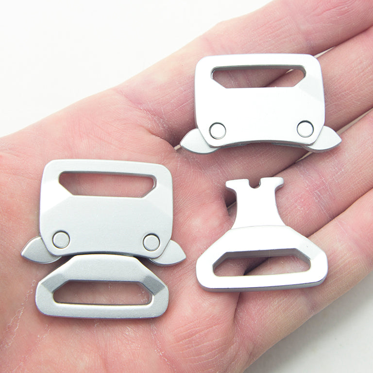 Close-up of a brushed silver tone buckle showing its quick release feature.