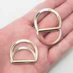 Close-up of gold tone 2-part locking D ring, size 42 x 34 mm.