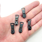 Close-up of a black water resistant zip pull with metal slider.