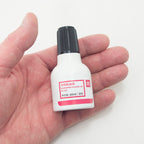 Close-up of 40 ml ink bottles designed for numbering machines.