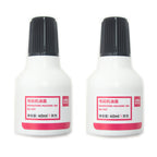 Two bottles of black ink for automatic numbering machine stamps.
