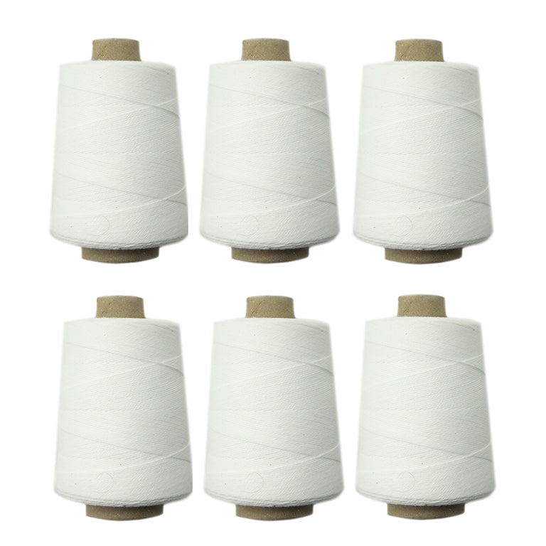Set of 6 spools of white cotton thread for sewing machines.