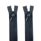 Two heavy duty black invisible zips with metal pulls.