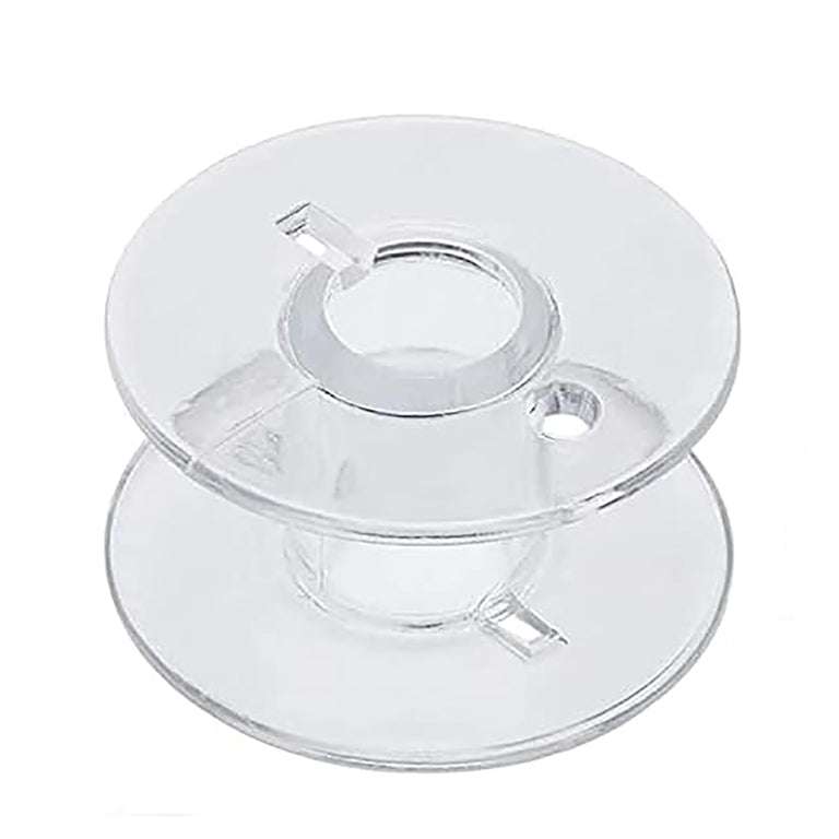 Close-up of a clear plastic bobbin suitable for domestic sewing machines.