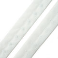 Close-up of white bra hook and eye tape showing hooks and eyes.