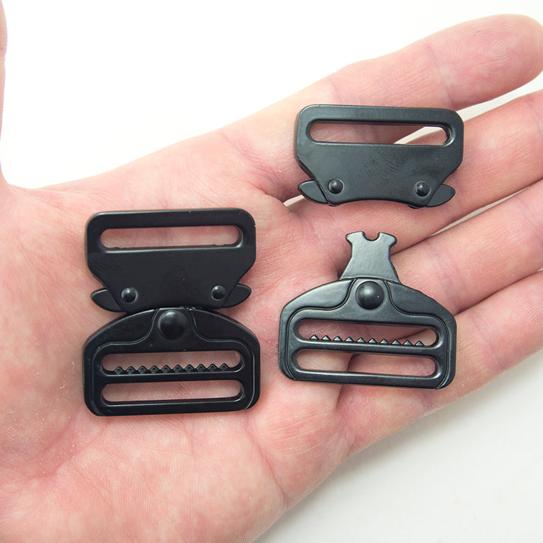 Close-up view of a matte black metal buckle showing its quick release mechanism.
