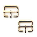 Two gold tone metal buckles, 34 x 25 mm, displayed on a white background.