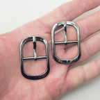Close-up of dark gunmetal buckles, 48 x 30 mm size.