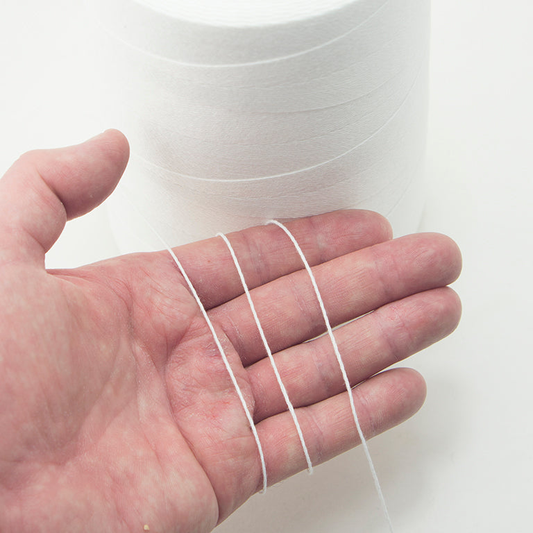Close-up of the extra strong synthetic thread for bag stitching.