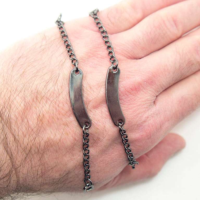 Close-up of metal sew on coat hangers with chain loops.