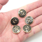Buttons arranged to show their 23 mm diameter size