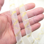 Close-up of lightweight millinery crin trim in white and gold