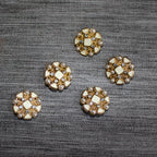 Close-up of ivory enamel button with gold tone setting