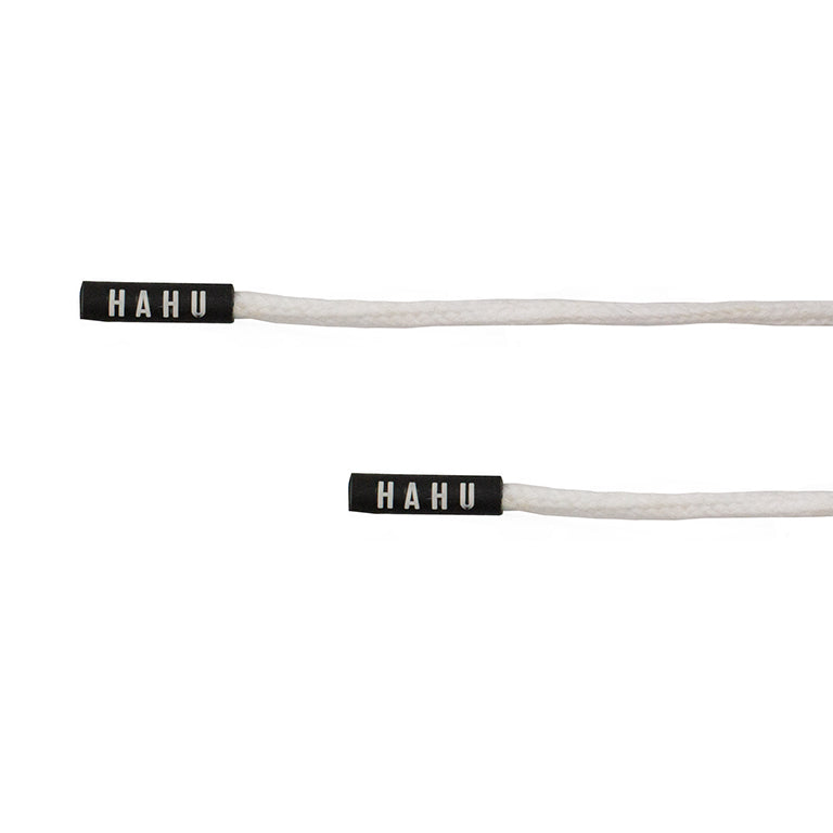 Close-up of HAHU cord ends on white cotton drawstrings.