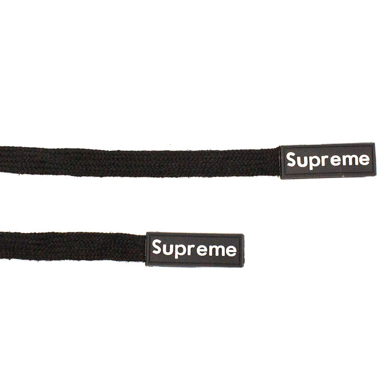Close-up of black cotton cords showing fine weave and rubber ends.