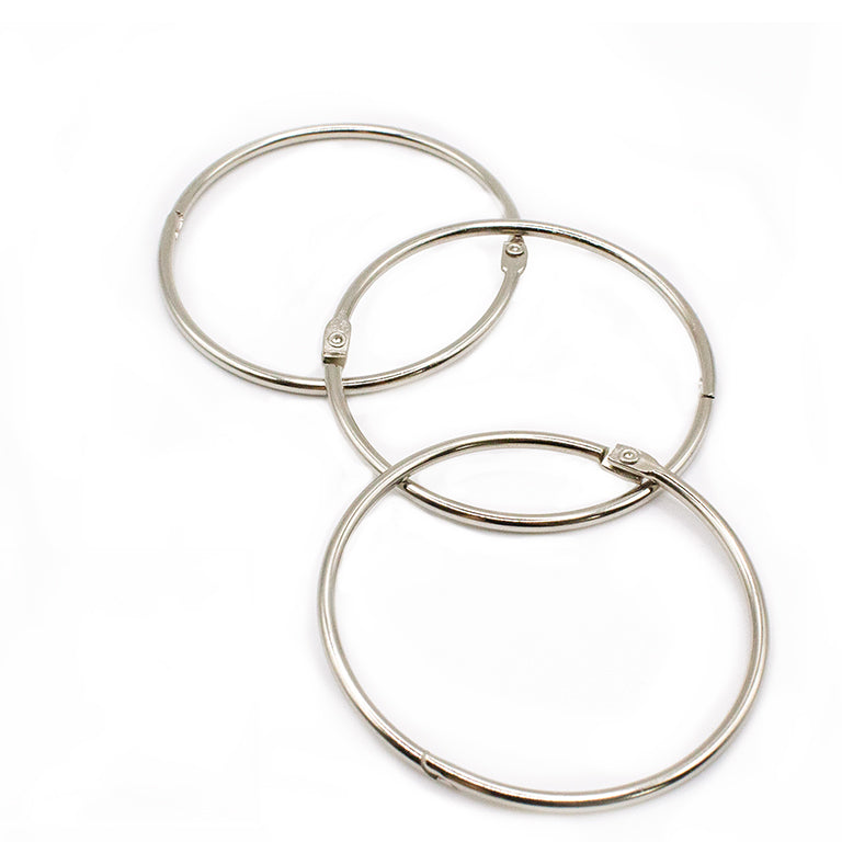 Close-up of a nickel-plated binding ring showing its locking mechanism.