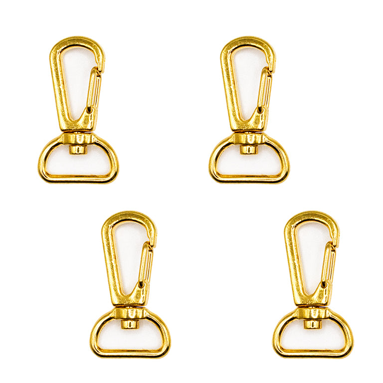 Four gold tone metal swivel snap hooks on a white background.