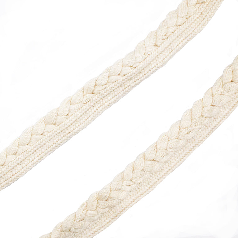 Cream cotton pipe trim with plait edge on a spool.