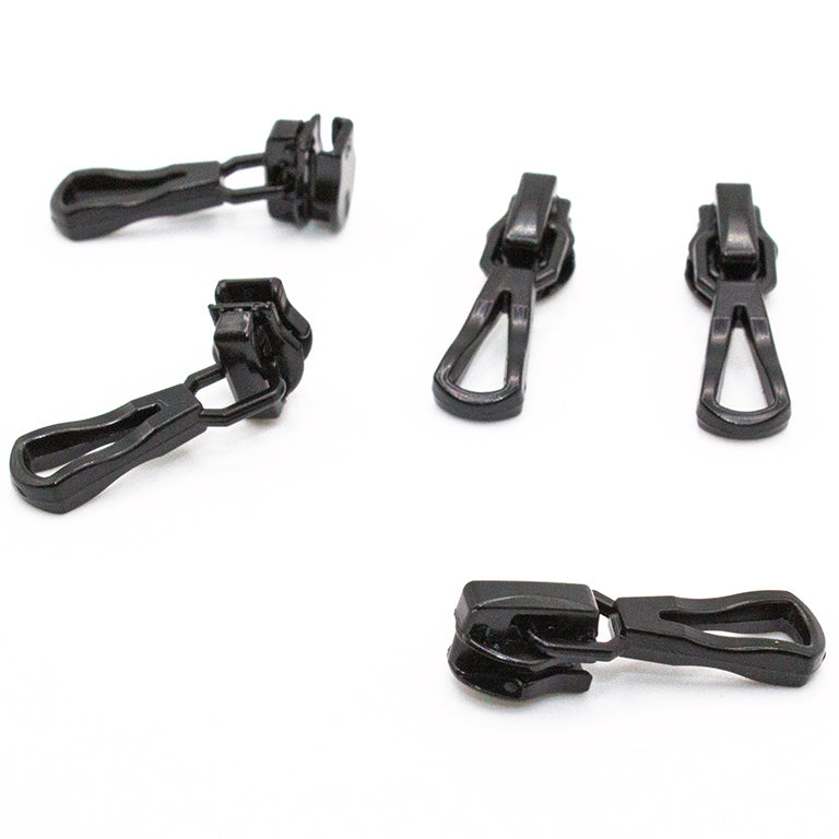 Close-up of a black metal zip pull showing the head slider.