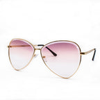 Pale rose pink women's polarized cat eye sunglasses on a white background.