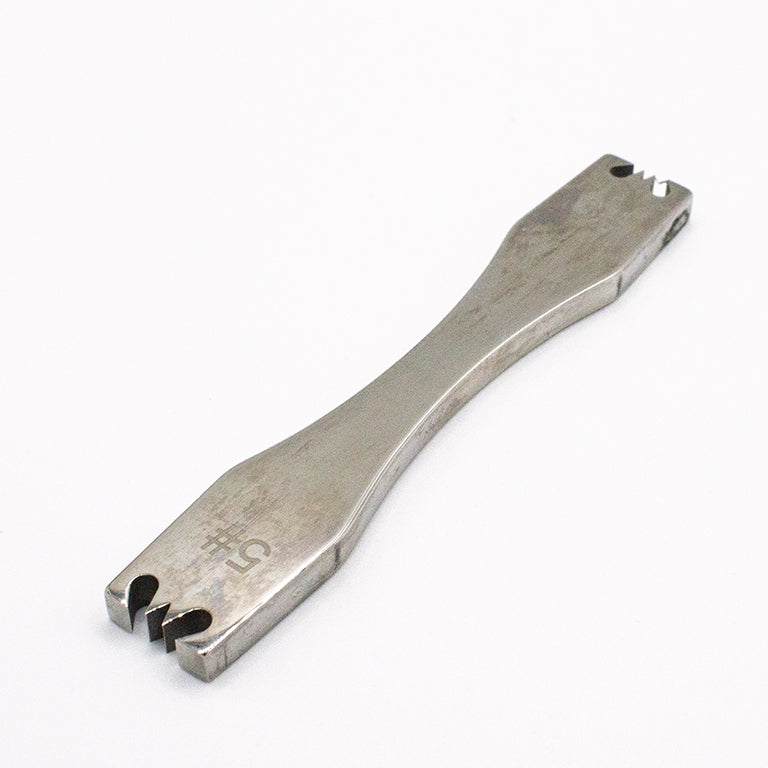 Close-up of the zipper teeth removal tool designed for sewing projects.