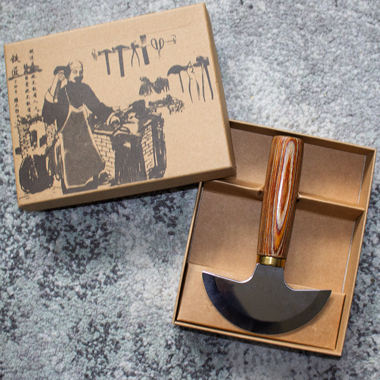 Close-up of the sharp blade of the leather knife showing its quality.