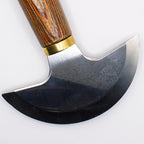 Leather knife displayed on a crafting surface with tools and materials.